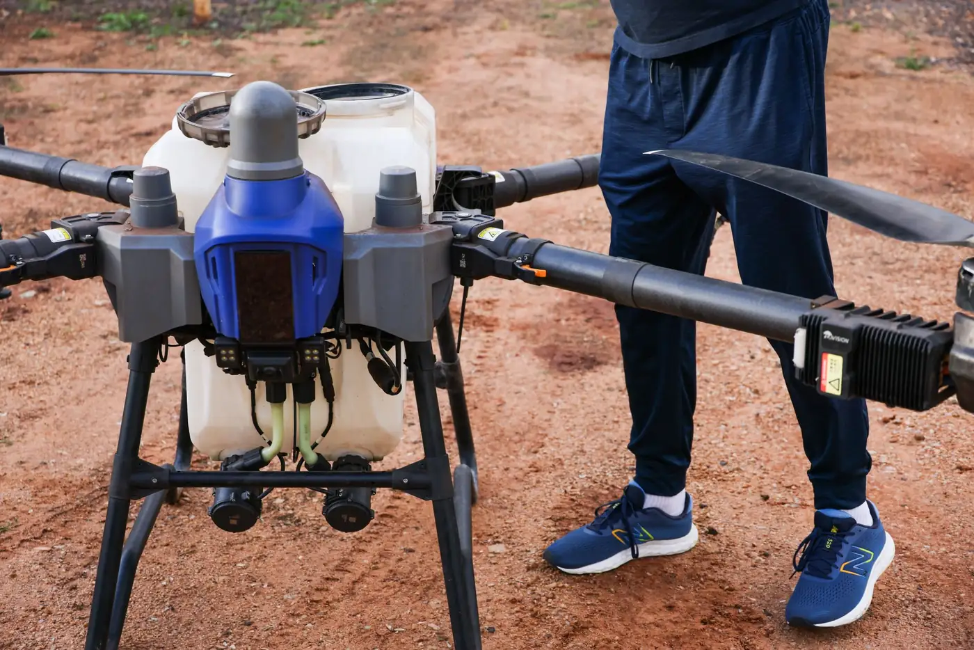 A drone pilot surveying a field