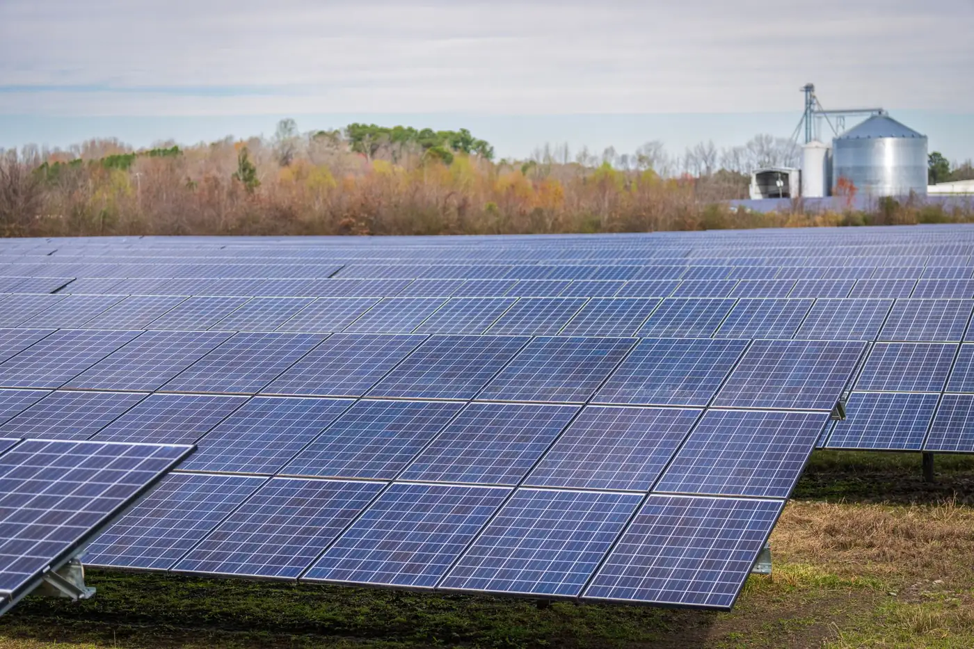 A solar array beside farm silos